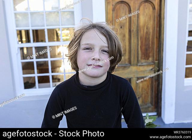 Young boy outside his home, portrait