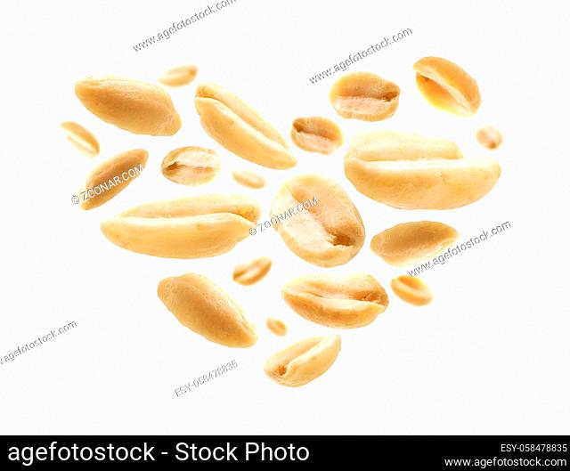Peeled peanuts in the shape of a heart on a white background