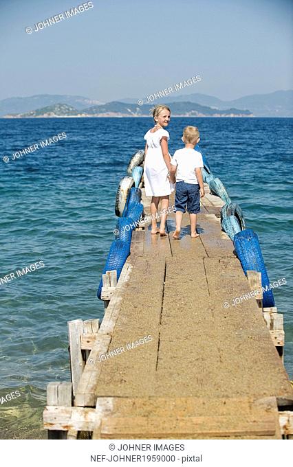 Brother and sister on jetty