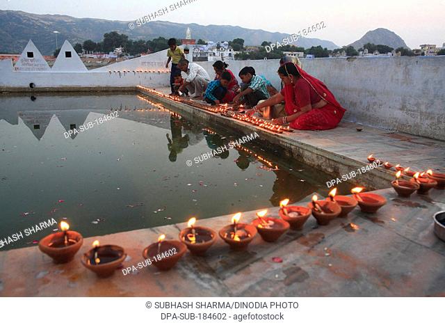 Family celebrating Diwali in Pushkar Lake at Rajasthan India