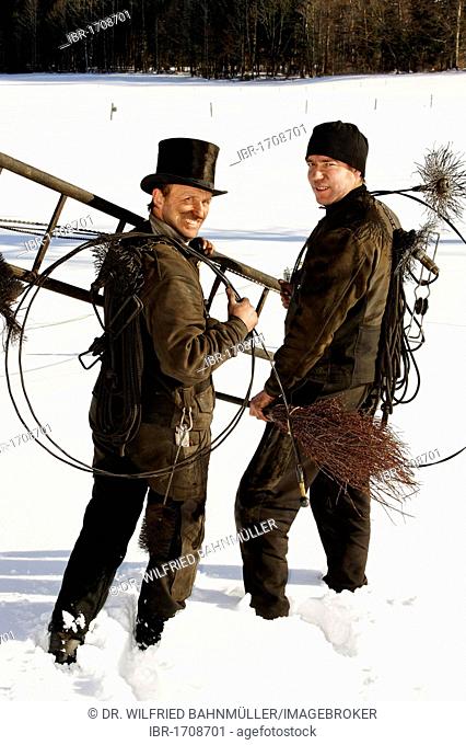 Two chimney sweeps in the snow