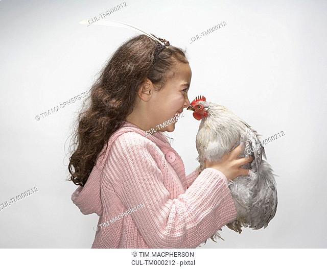 Girl looking at hen