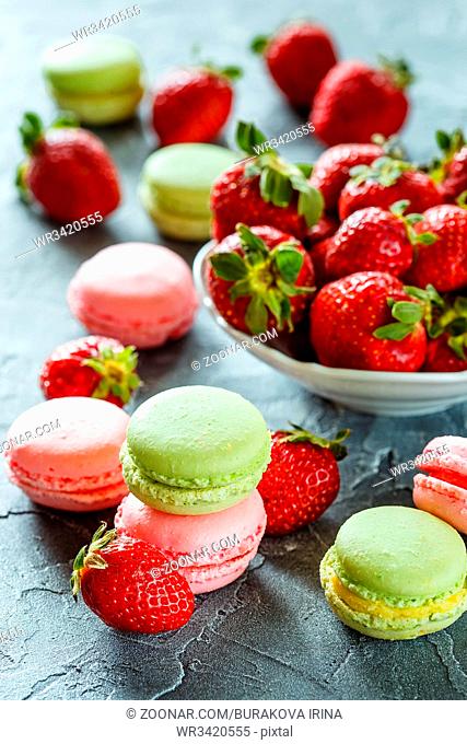 Strawberry Pink and green Macaroons with fresh strawberries on grey background