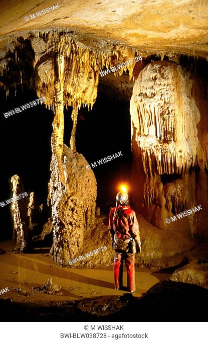 cave, Grotte Malatiere, caver and dropstone formation, France, Doubs