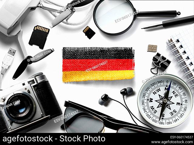 Flag of Germany and travel accessories on a white background. The view from the top