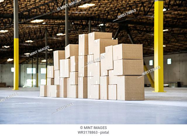 Group of cardboard boxes in a brand new large warehouse space