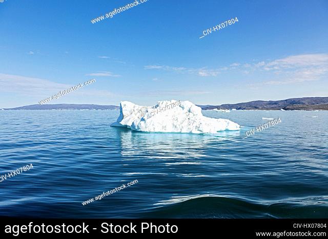 Melting polar ice on sunny blue Atlantic Ocean Greenland