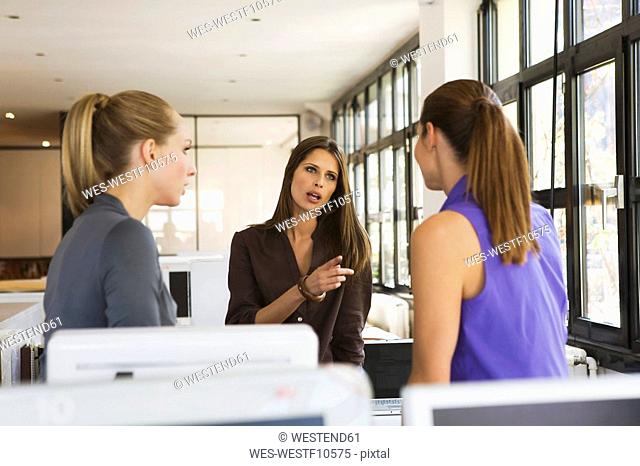 Three women in office having an argument