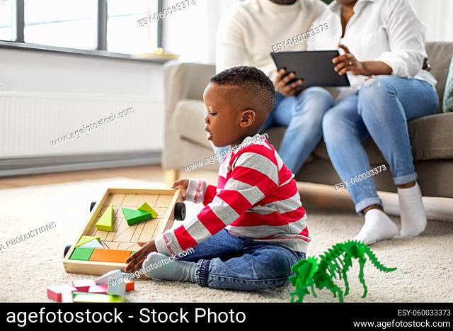 african american boy playing with toys at home