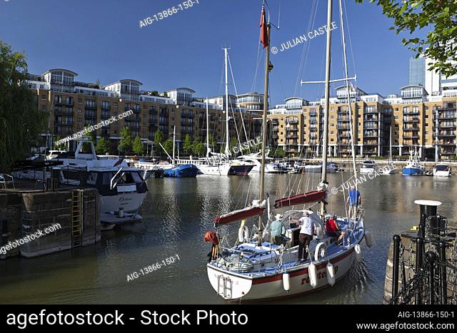 A sailboat enters St Katherine's Dock, London, E1, England, UK