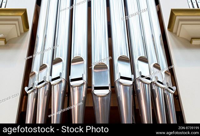 Close-up of modern steel organ pipe set horizontal