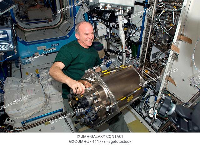 NASA astronaut Jeffrey Williams, Expedition 22 commander, installs a Urine Processor Assembly Distillation Assembly (UPA DA) in the Water Recovery System (WRS)...