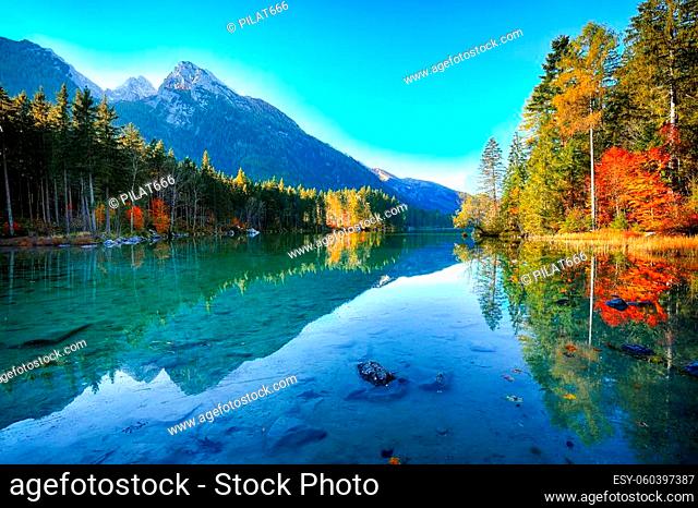 Fantastic autumn sunrise of Hintersee lake. Beautiful scene of trees near turquoise water of Hintersee lake. Location: resort Ramsau