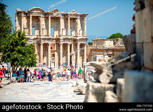 EPHESUS, TURKEY - AUG 01: visitors in Curetes street on August 01, 2014 in Ephesus, Turkey. Ancient Ephesus contains the largest collection of Roman ruins in...