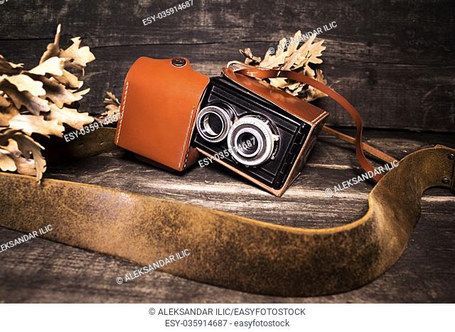 Vintage photo camera on a wooden surface