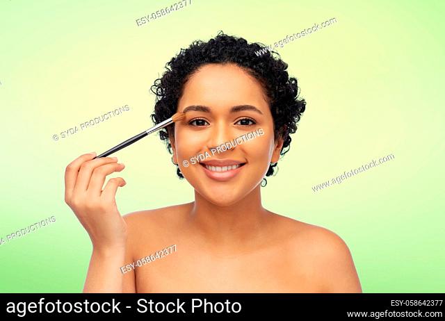 african american woman with make up brush