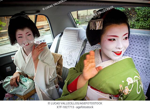 Fukuyu, geisha and Fukukimi, 'maiko' geisha apprenticein taxi going to work They say goodbye at Oka san  Geisha's distric of Miyagawacho Kyoto  Kansai, Japan