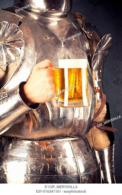knight wearing armor and holding mug of beer