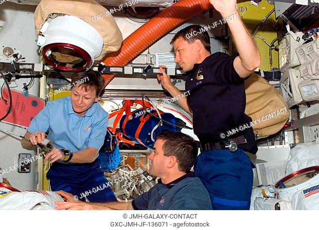 Astronauts Peggy Whitson, Expedition 16 commander; Stanley Love and Rex Walheim (bottom), both STS-122 mission specialists