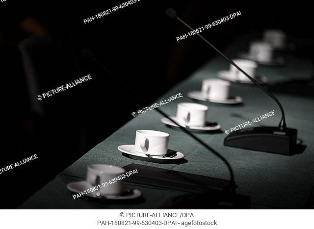16 Agust 2018, Germany, Hamburg: A row of empty cups is standing on a table in the Great Hall of the Hamburg City Hall in front of the last meeting of the G20...