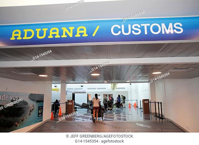 Nicaragua, Managua, Augusto C  Sandino International Airport, MGA, terminal, concourse, customs, sign, bilingual, Spanish, English, passenger, woman, baggage
