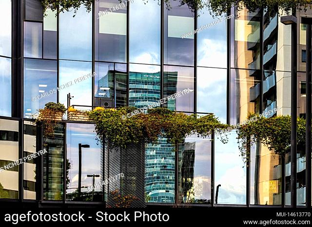Modern office buildings reflected in a contemporary cityscape