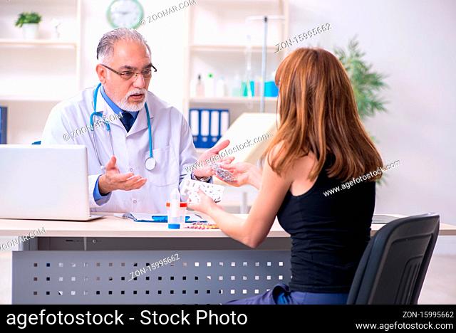 Young woman visiting old doctor