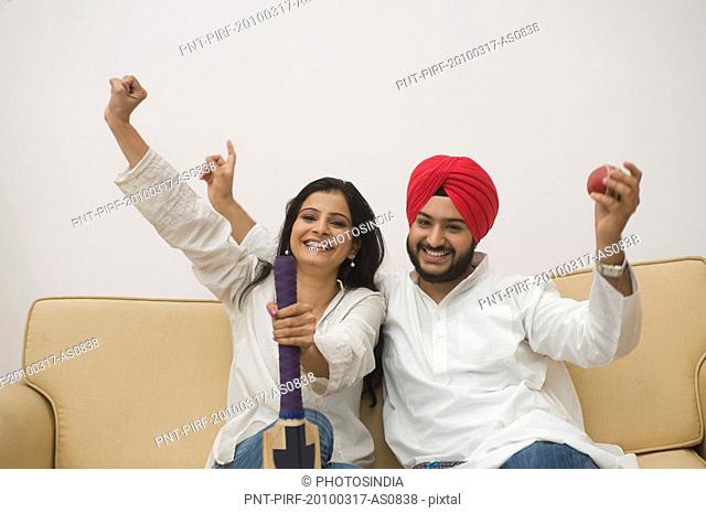 Sikh couple watching television