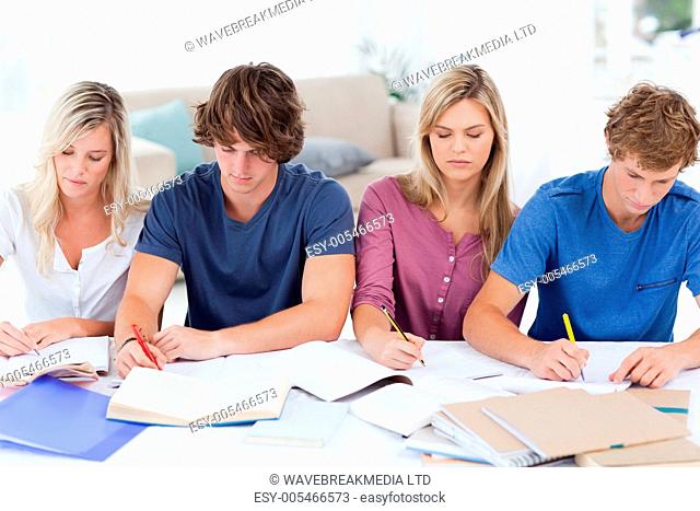 Four students sitting together and studying