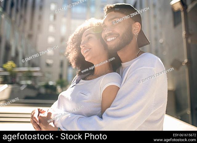 Happiness. Lovely young couple in sunlight looking happy
