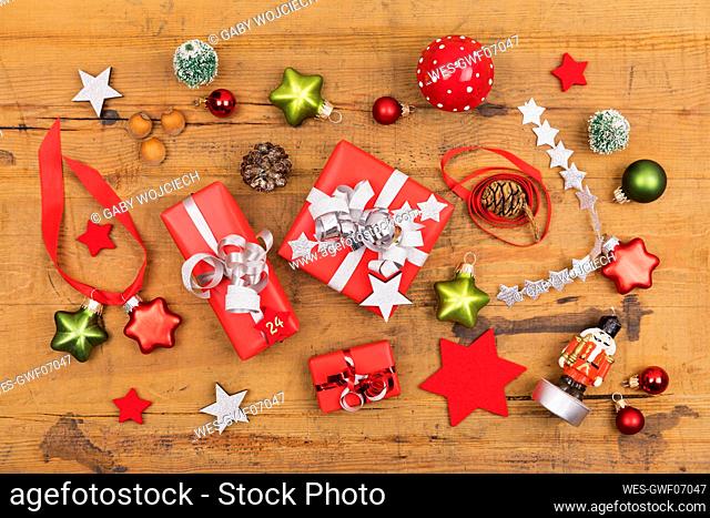 Collection of Christmas themed items flat laid on wooden surface