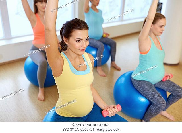 pregnant women training with exercise balls in gym