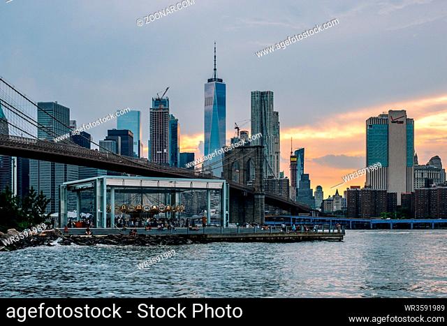 Brooklyn NY - USA - Jun 28 2019: Lower Manhattan skyline and Brooklyn bridge at sunset