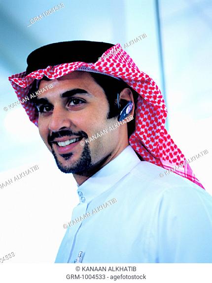 Arab businessman with Bluetooth headset