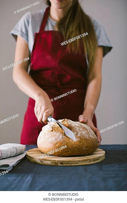 Woman chopping fresh hand made bread