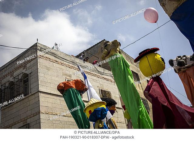 21 March 2019, Palestinian Territories, Hebron: Israelis take part in a parade celebrating the Jewish holiday of Purim. The carnival-like Purim holiday is...
