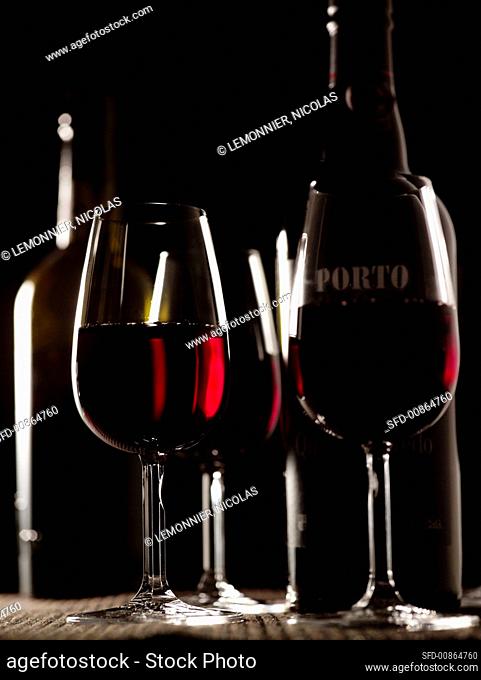 Port wine in three glasses and two bottles
