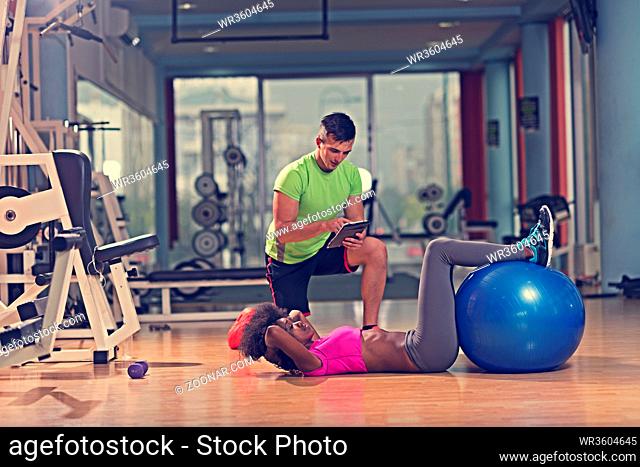 healthy young couple exercise in gym pilates workout with personal trainer