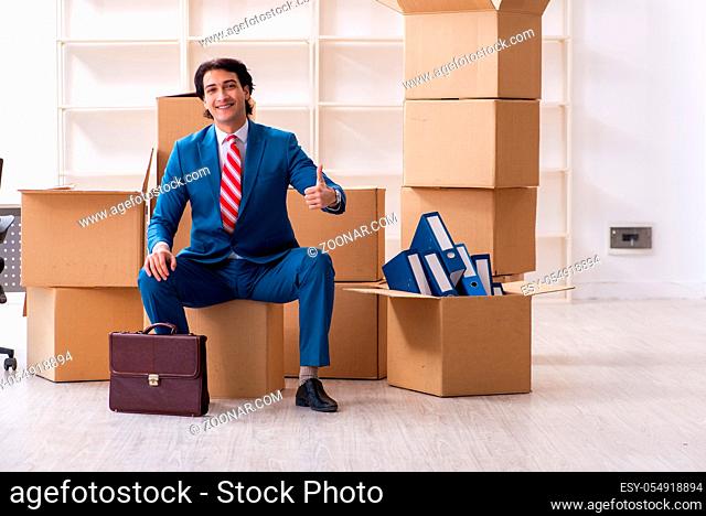Young handsome businessman moving to new workplace