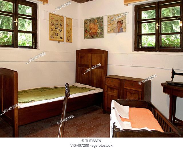 interior view from an old cottage farmhouse sleepingroom room with bed and cradle in the flower park Mozirski Gaj in the town Mozirje in the in the valley of...