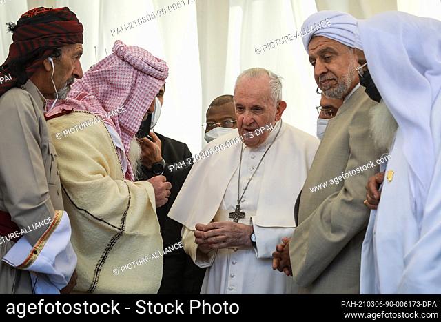 06 March 2021, Iraq, Nasiriyah: Pope Francis (C) speaks with religious clerics from different sects in Iraq during an interreligious meeting in the Sumerian...
