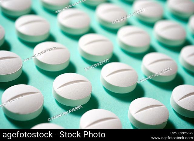 Pills on a green table