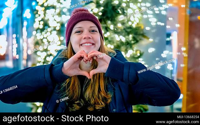 Young girl forms a heart with her hands - travel photography