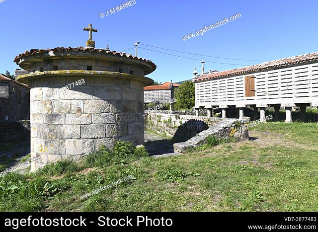 Traditional dovecote of granite stone. At bottom traditional granaries (horreos). Carnota, A Coruna, Galicia, Spain