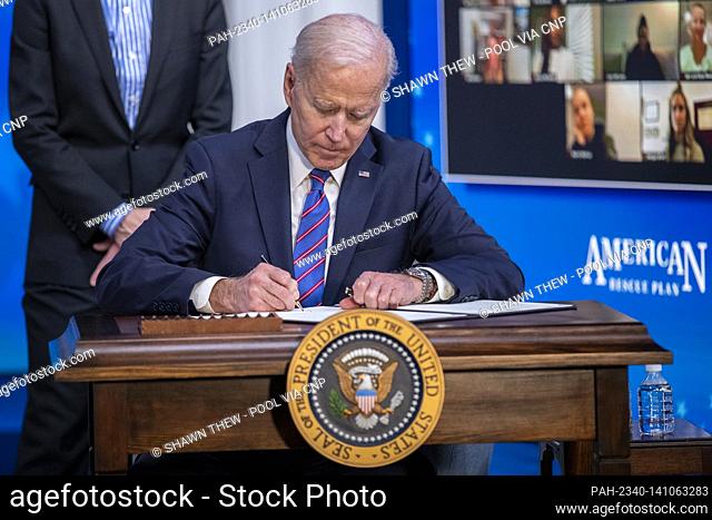 US President Joe Biden signs a proclamation during an event to mark Equal Pay Day in the State Dining Room of the White House in Washington, DC, USA