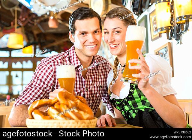 Couple drinking wheat beer in bavarian restaurant