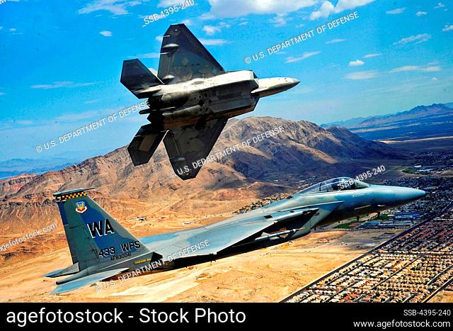 An F-22 Raptor pitches out for landing while an F-15 Eagle flies the approach at Nellis Air Force Base, Nev., on 16 July, 2010