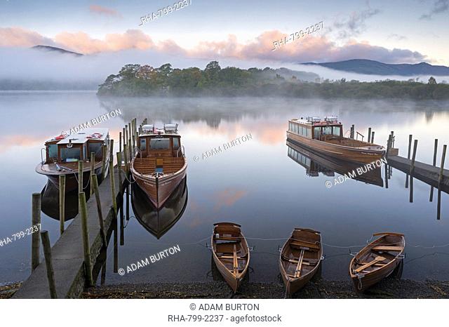 Boats on Derwent Water on a misty autumn morning, Lake District National Park, Keswick, Cumbria, England, United Kingdom, Europe