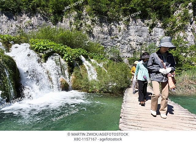 The Plitvice Lakes in the National Park Plitvicka Jezera in Croatia  Visitors on the plank paths of the national Park  The Plitvice Lakes are a string of lakes...
