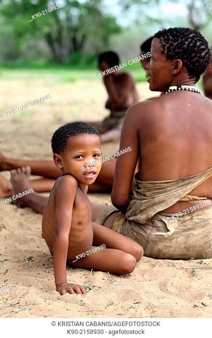 Kid sitting besides his mother, Namibia, Africa